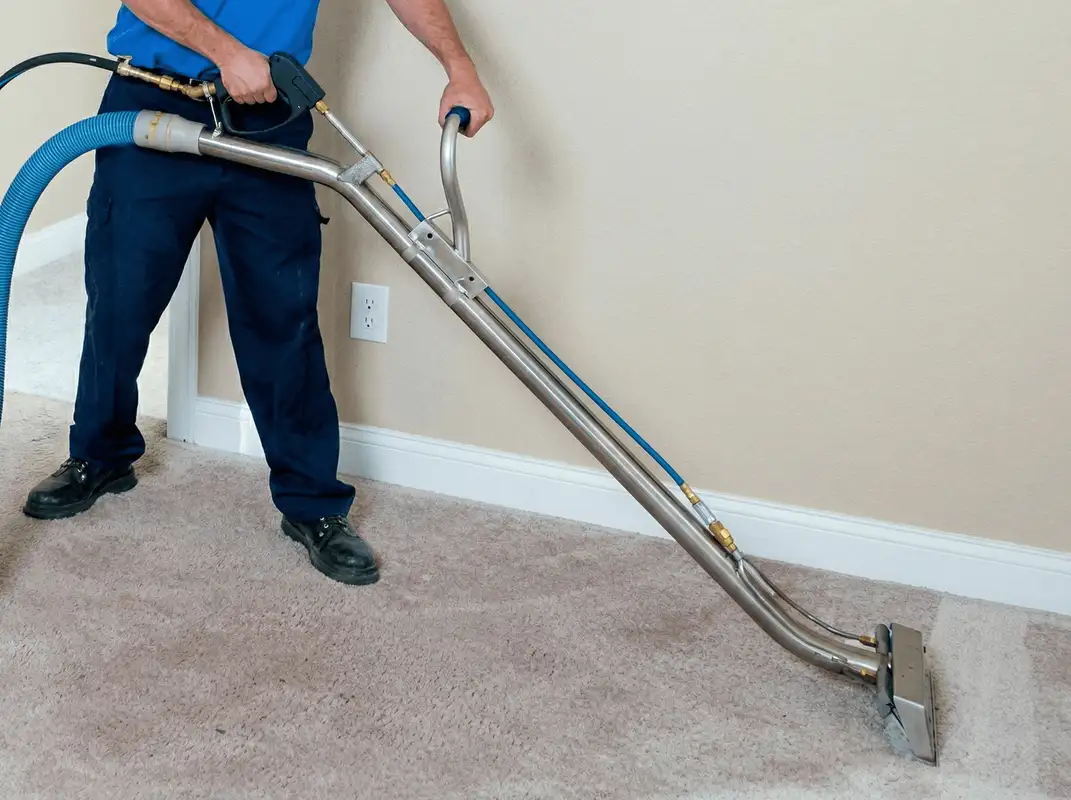Professional operating a liquid removal machine on a carpeted floor in Minneapolis, MN